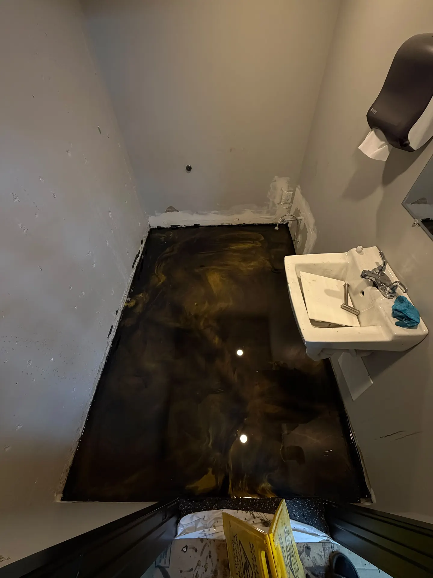 Dark metallic epoxy washroom floor, by Westside Mogul Resin in Calgary