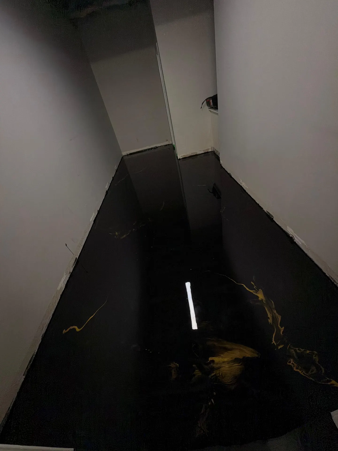 Black metallic epoxy hallway floor by Westside Mogul Resin in Calgary