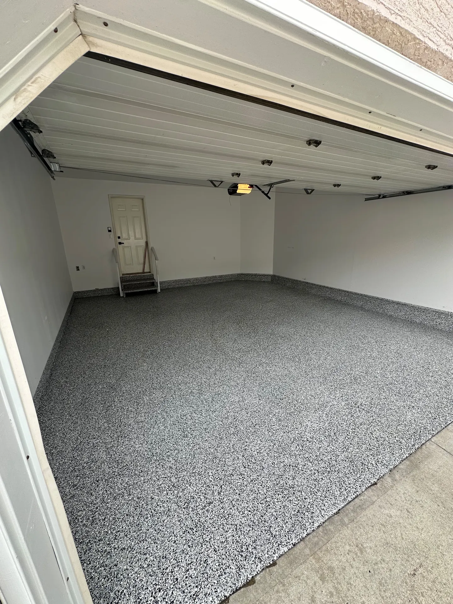 Black and white flake epoxy garage floor, by Westside Mogul Resin in Calgary