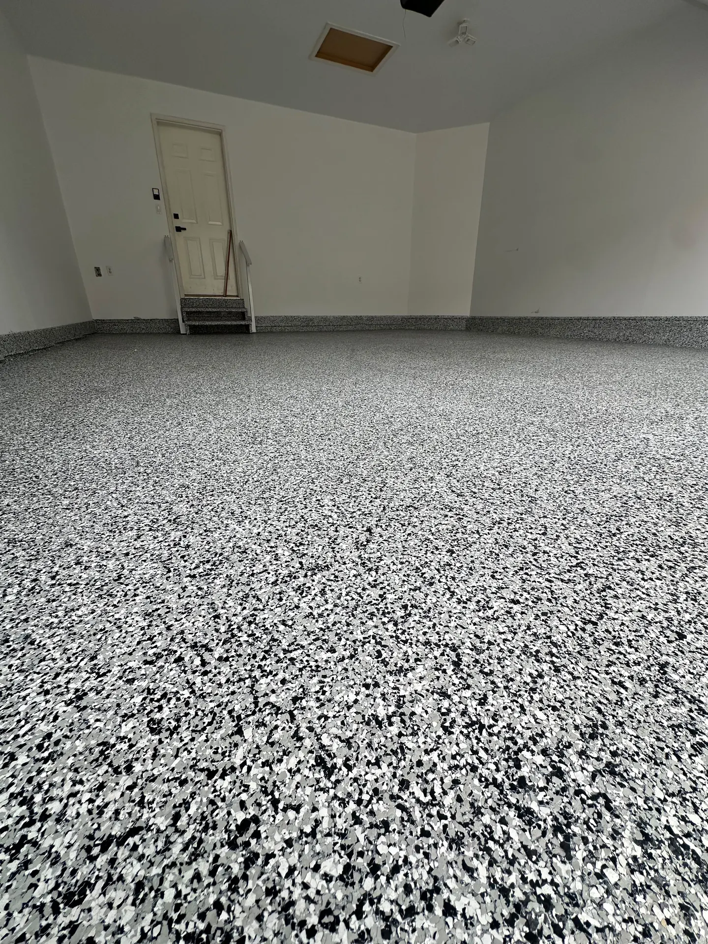 Black and white flake epoxy garage floor, by Westside Mogul Resin in Calgary
