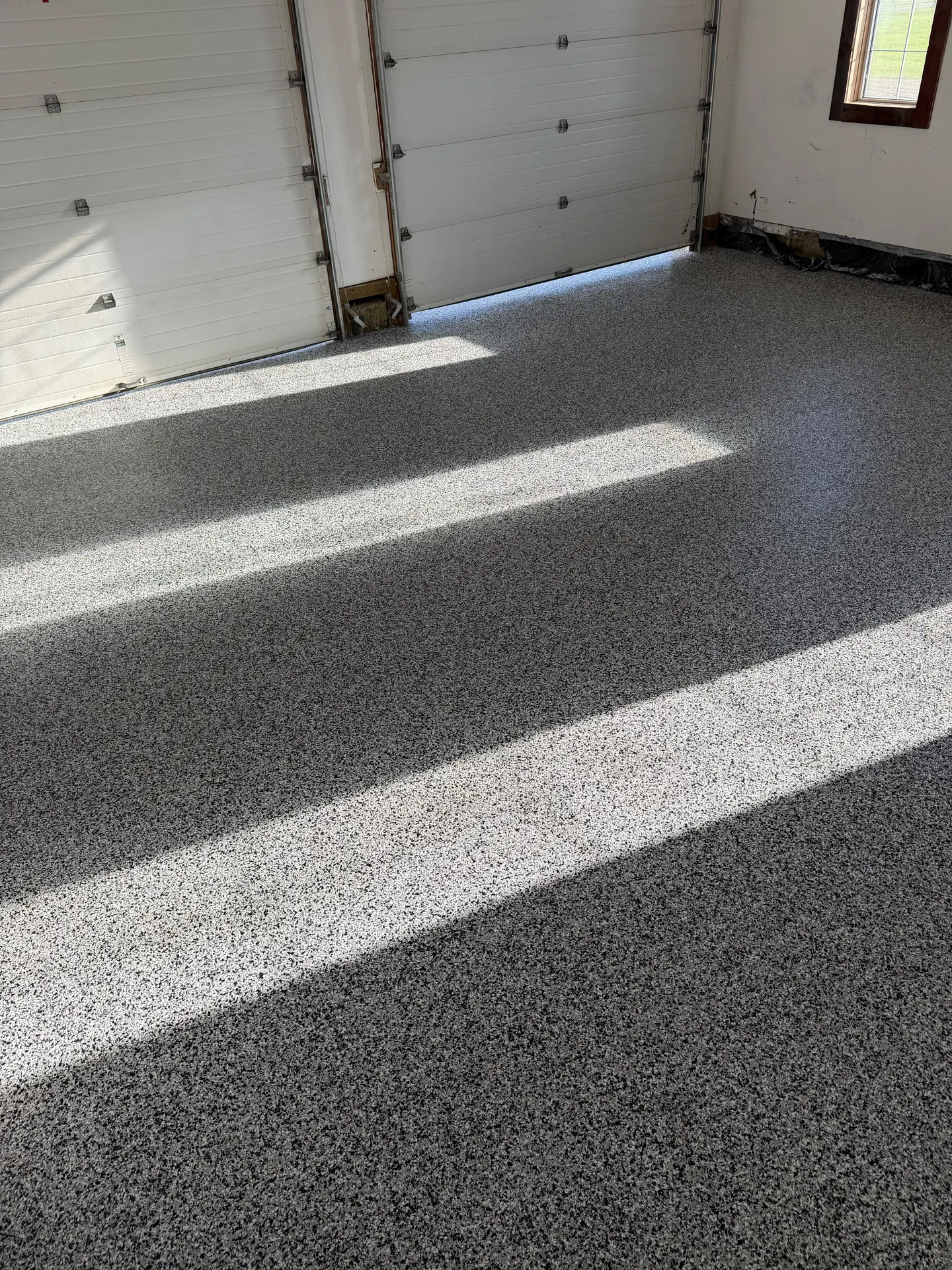 Flake epoxy garage floor in sunlight, by Westside Mogul Resin in Calgary