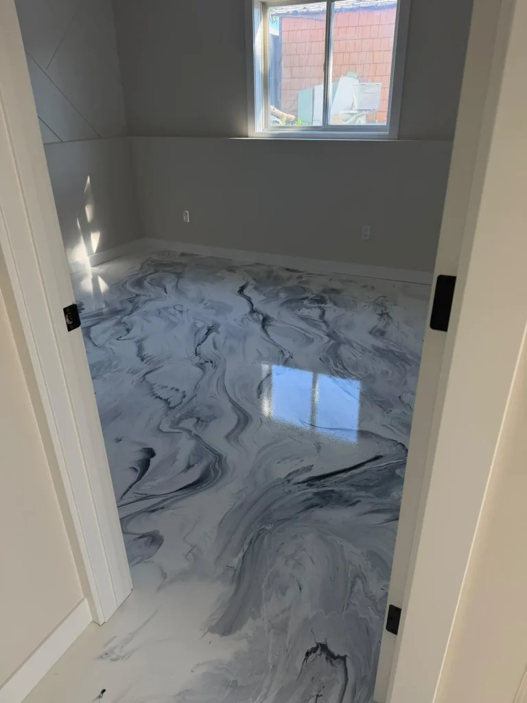 White and black marble metallic epoxy floor, doorway view, by Westside Mogul Resin in Calgary